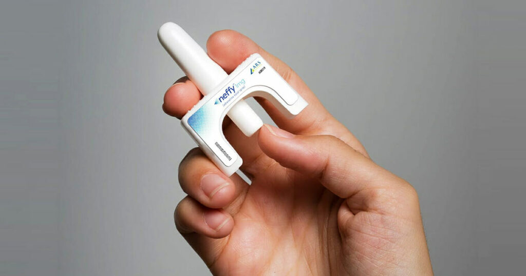 Hand holding a new device to administer epinephrine without a needle. It used forced air though the nasal cavity to delivery relief.