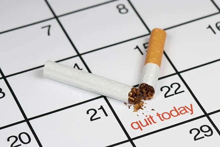 Image of calendar with quit smoking date highlighted and a broken cigarette